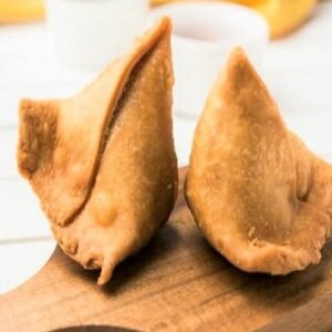 Crispy golden vegetable samosas filled with spiced potatoes and peas, served hot with mint chutney – a classic Indian starter.